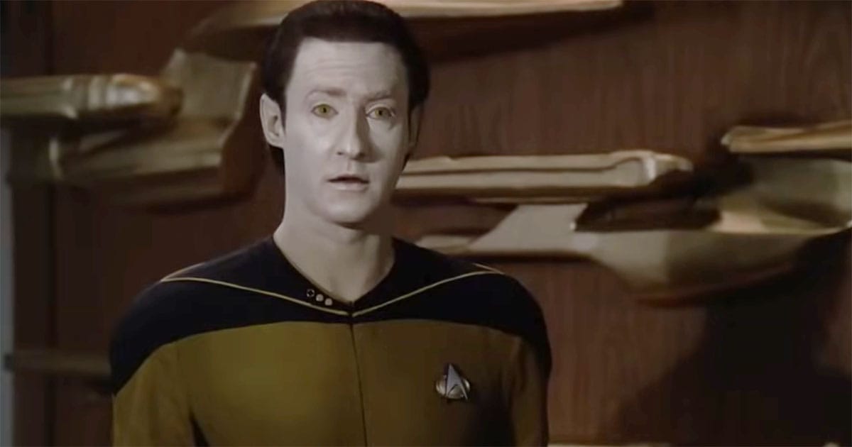 Data standing and listening in Star Trek The Next Generation.