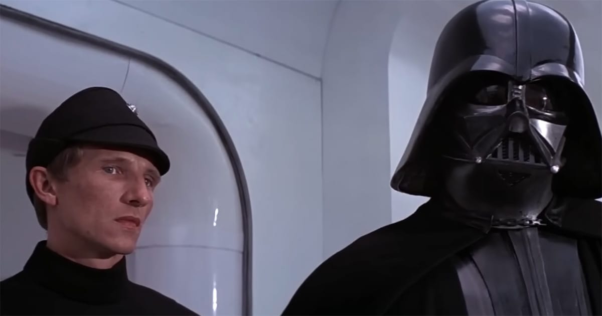 Darth Vader standing beside Imperial officer with breathing mask visible in Star Wars Episode IV A New Hope.