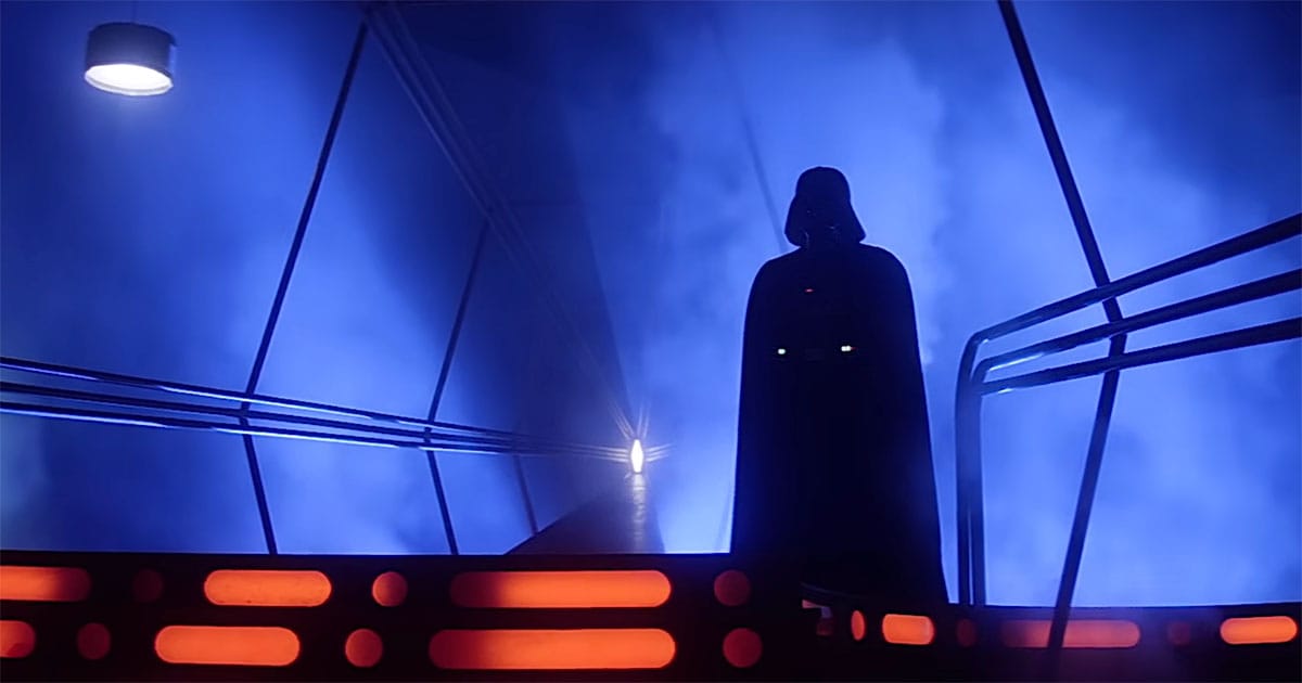 Darth Vader standing alone in blue-lit Imperial corridor with smoke in Star Wars Episode IV A New Hope.