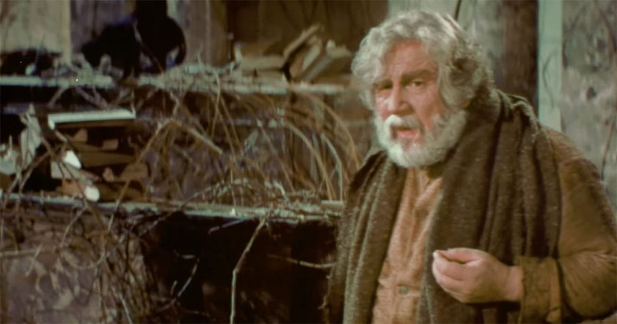 An elderly man standing among ruins and books in the 1976 science fiction film Logan’s Run.