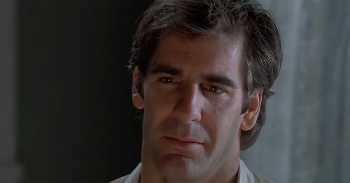 Sam Beckett stands alone in quiet reflection after completing a leap, his expression showing the lasting impact of the lives he has helped.