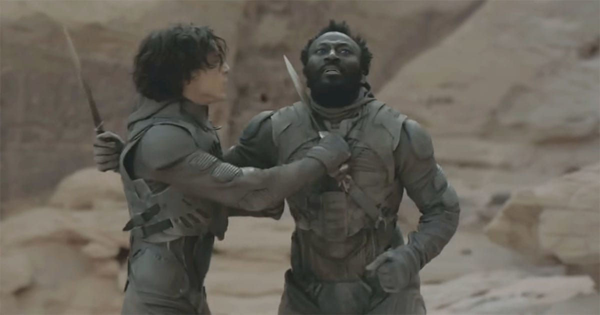 Paul Atreides pressing a crysknife against Jamis during their ritual duel in Denis Villeneuve’s Dune.