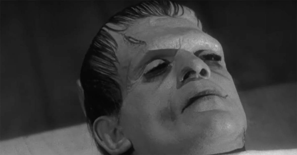 Close-up of the creature lying on a table in the 1931 film Frankenstein, shown in a still, abstract moment without visible machinery.