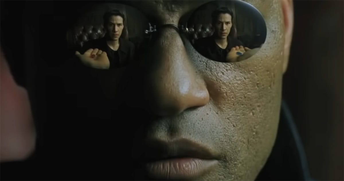 Morpheus reflected in dark glasses as Neo considers the red and blue pills in The Matrix, representing choice and the cost of knowledge.