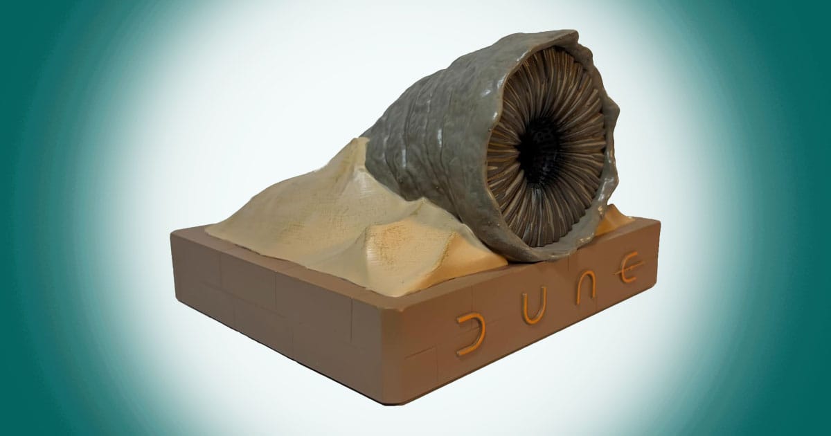 Dune sandworm collectible speaker statue Shai-Hulud emerging from desert sand base.