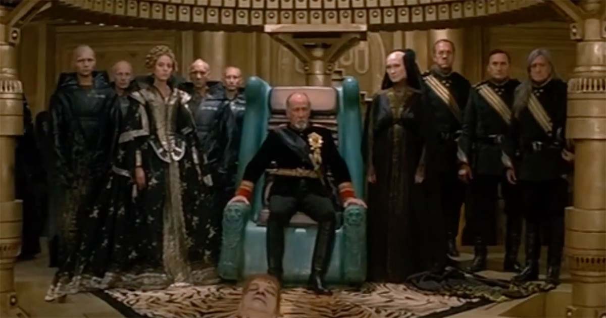 Padishah Emperor Shaddam IV seated on the throne with members of the imperial court in the "Dune" throne chamber.
