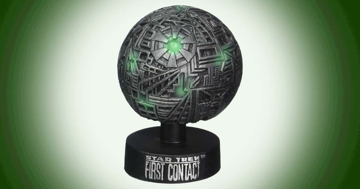 Star Trek First Contact Borg Sphere model with green illuminated details on display base.