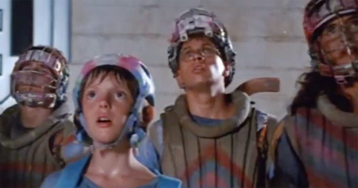 Teenage characters in futuristic gear looking upward in awe beneath the Eco Protectorate emblem in Solarbabies