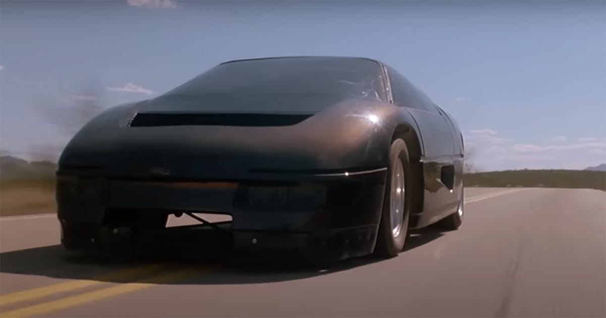 Close-up of the Dodge M4S Turbo Interceptor racing on an open desert road under clear skies in "The Wraith" (1986).