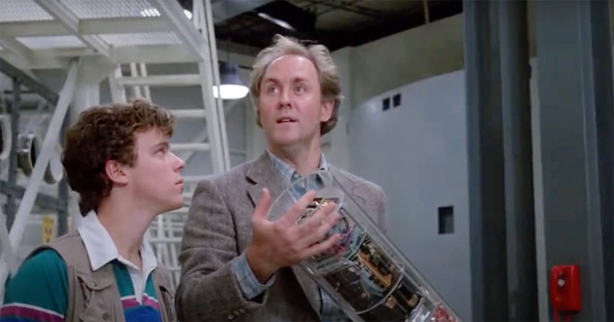 Paul Stephens and the scientist examine a transparent container holding advanced technology inside a government laboratory in “The Manhattan Project” (1986).