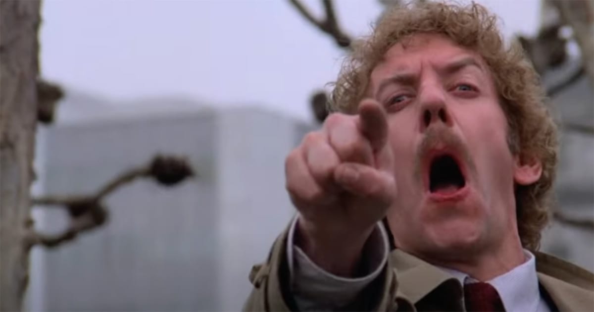Donald Sutherland pointing and screaming in the final scene of the 1978 movie Invasion of the Body Snatchers, capturing paranoia and exposure of humanity’s last survivors.