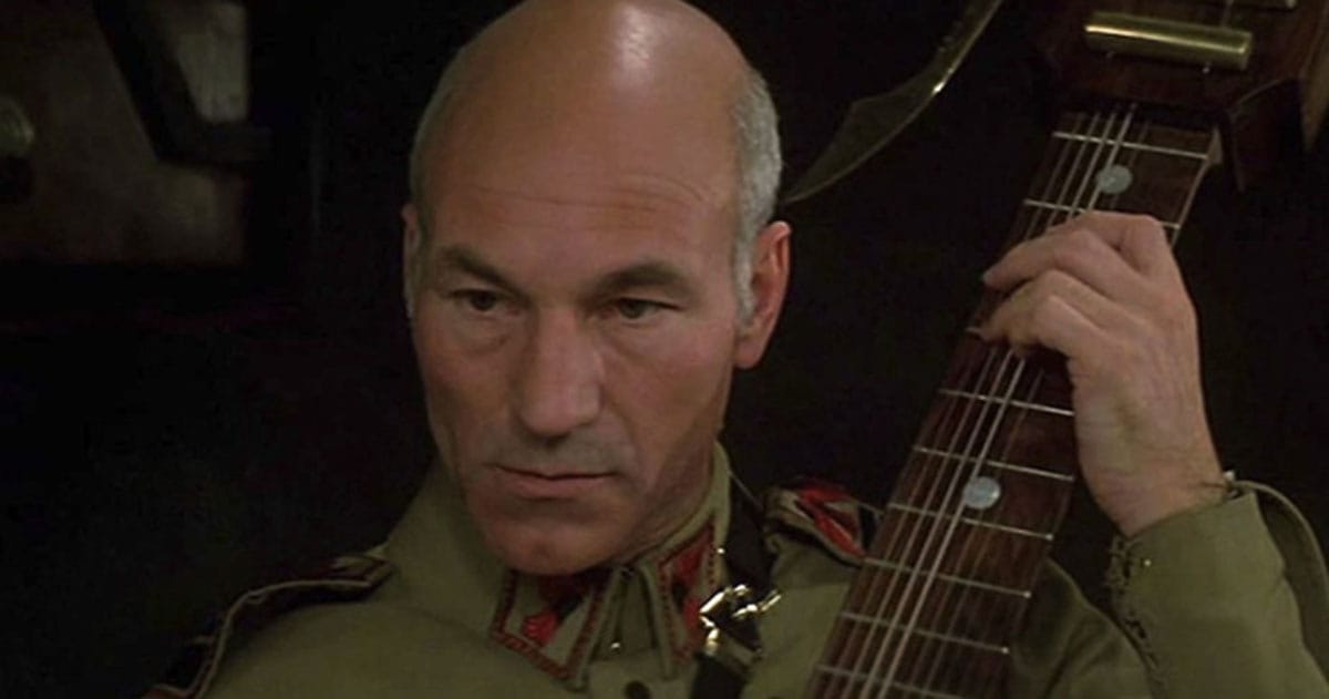 Patrick Stewart as Gurney Halleck playing the baliset in Dune (1984 film adaptation).