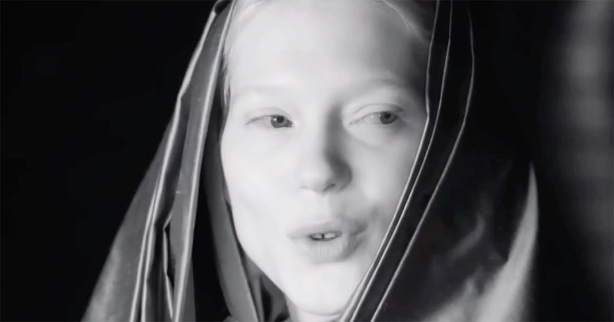 Black-and-white close-up of Lady Margot Fenring in a Bene Gesserit veil, her expression calm and observant, suggesting quiet authority within the imperial court.