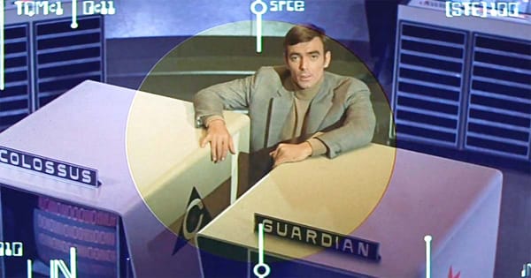 A screen capture showing the Dr. Forbin character between monitors for two AIs.