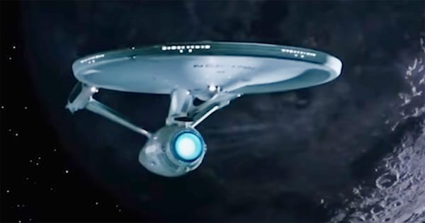 The U.S.S. Enterprise NCC-1701 from "Star Trek: The Original Series" flying through deep space against a starfield background.