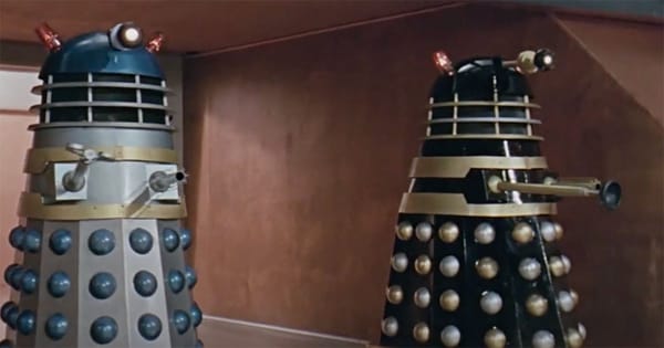 Two Daleks from classic Doctor Who standing in a futuristic corridor, representing Roy Skelton’s iconic voice work.