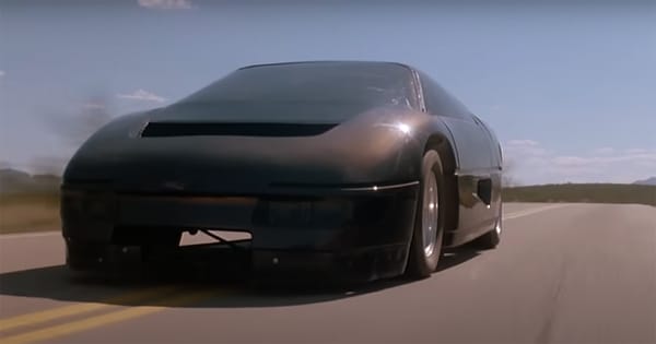 Close-up of the Dodge M4S Turbo Interceptor racing on an open desert road under clear skies in "The Wraith" (1986).