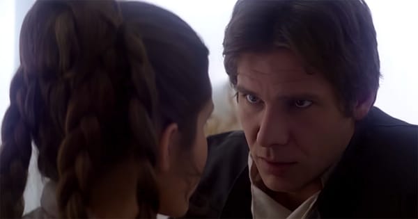 Han Solo looks intently at Leia aboard the Millennium Falcon, showing calm determination amid rising danger.
