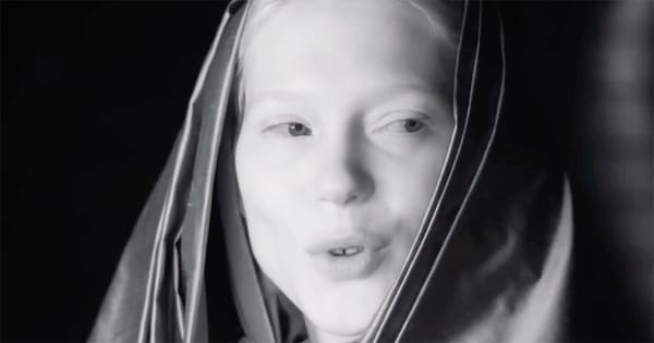 Black-and-white close-up of Lady Margot Fenring in a Bene Gesserit veil, her expression calm and observant, suggesting quiet authority within the imperial court.