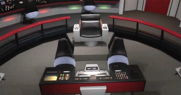The captain’s chair centered on the Starship Enterprise bridge from Star Trek, shown empty and framed by control consoles.