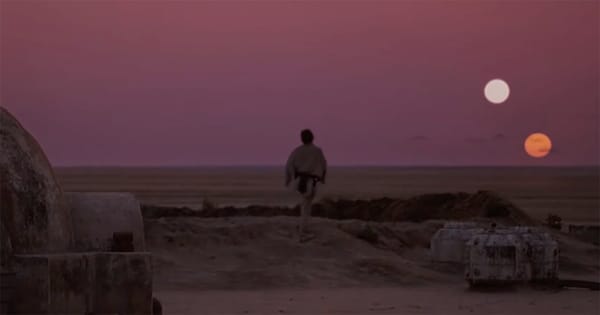 Luke Skywalker watching twin suns set over Tatooine desert in Star Wars Episode IV A New Hope.